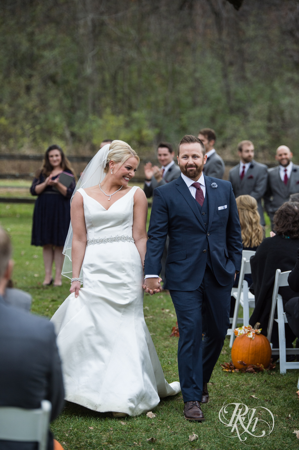 Bride and groom smile after outdoor wedding ceremony at Mayowood Stone Barn in Rochester, Minnesota.