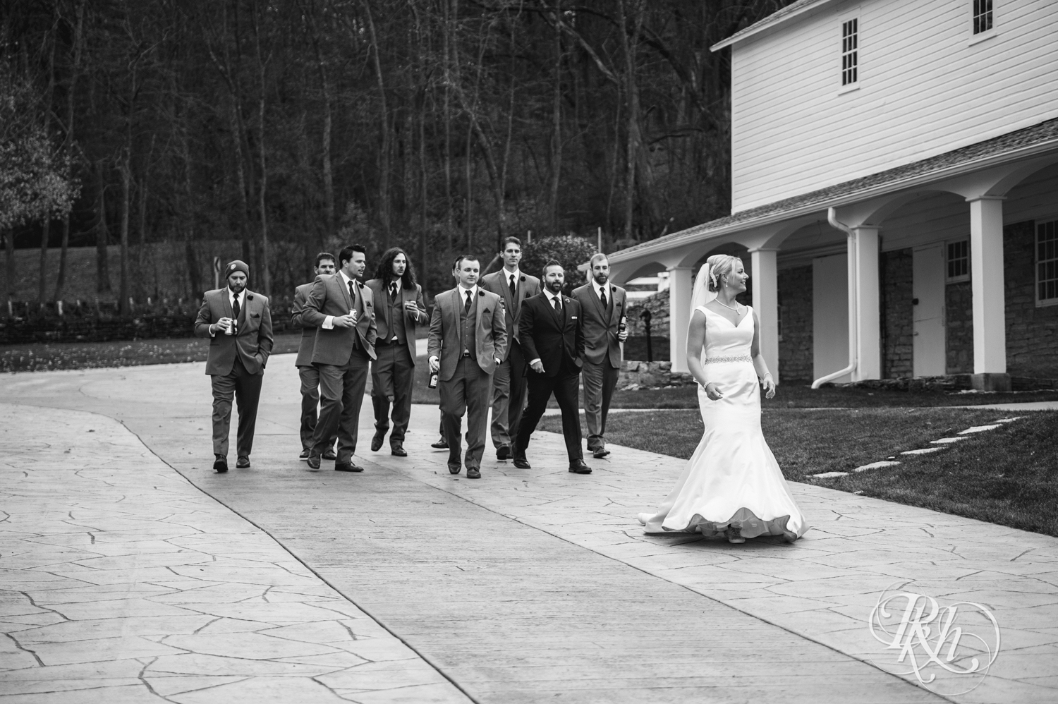 Bride leads all the groomsmen at wedding reception at Mayowood Stone Barn in Rochester, Minnesota.