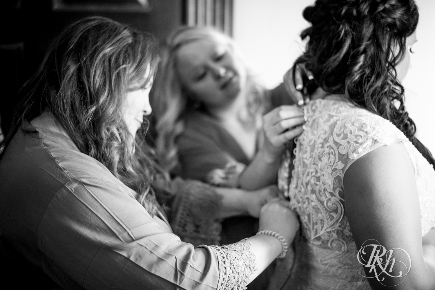 Bride getting buttoned into wedding dress at Kellerman's Event Center in White Bear Lake, Minnesota.