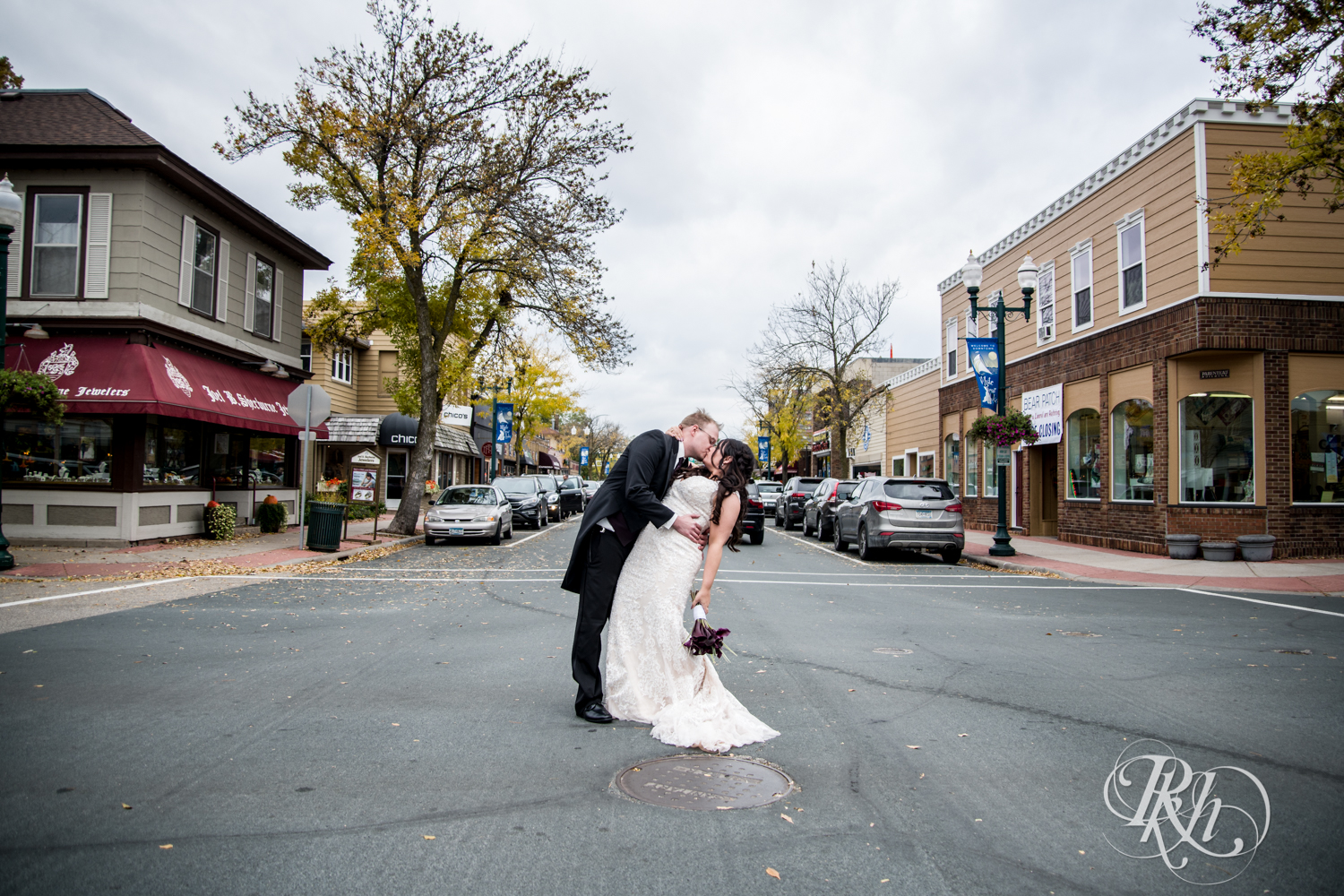 Bride and groom kiss in street at Kellerman's Event Center in White Bear Lake, Minnesota.