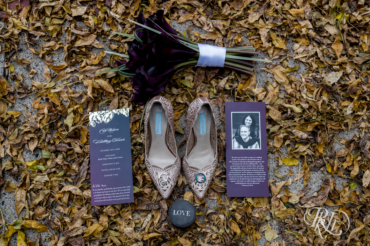 October wedding invites, rings and flowers in the leaves.