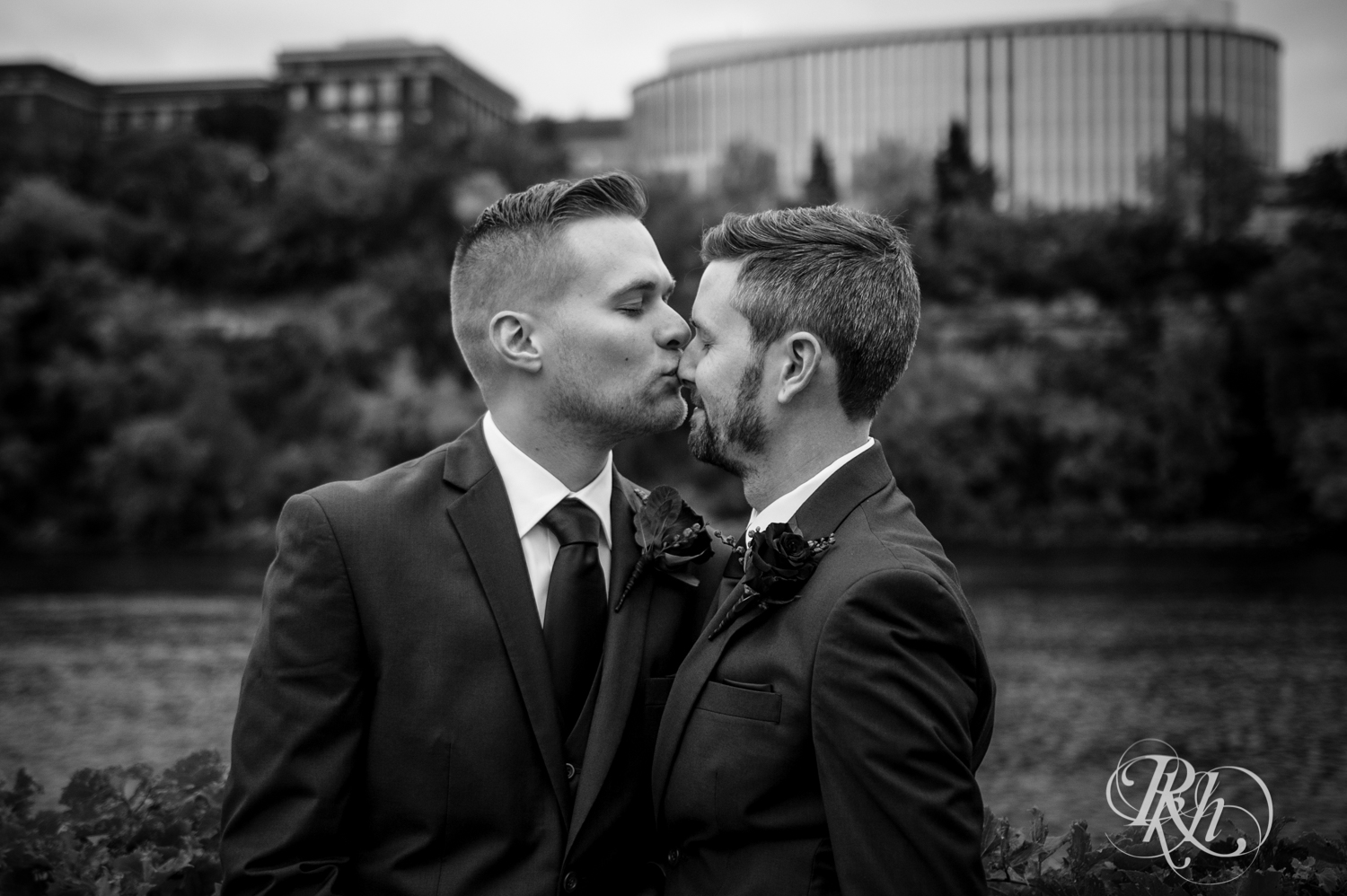 Grooms kiss at Bohemian Flats Park in Minneapolis, Minnesota for Minnesota LGBT wedding photographer.