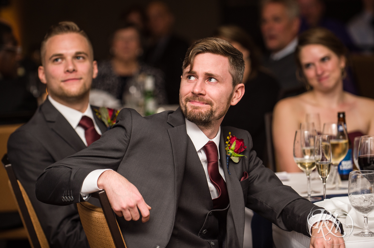 Groom cries during speeches at wedding reception at at Courtyard by Marriott Minneapolis.