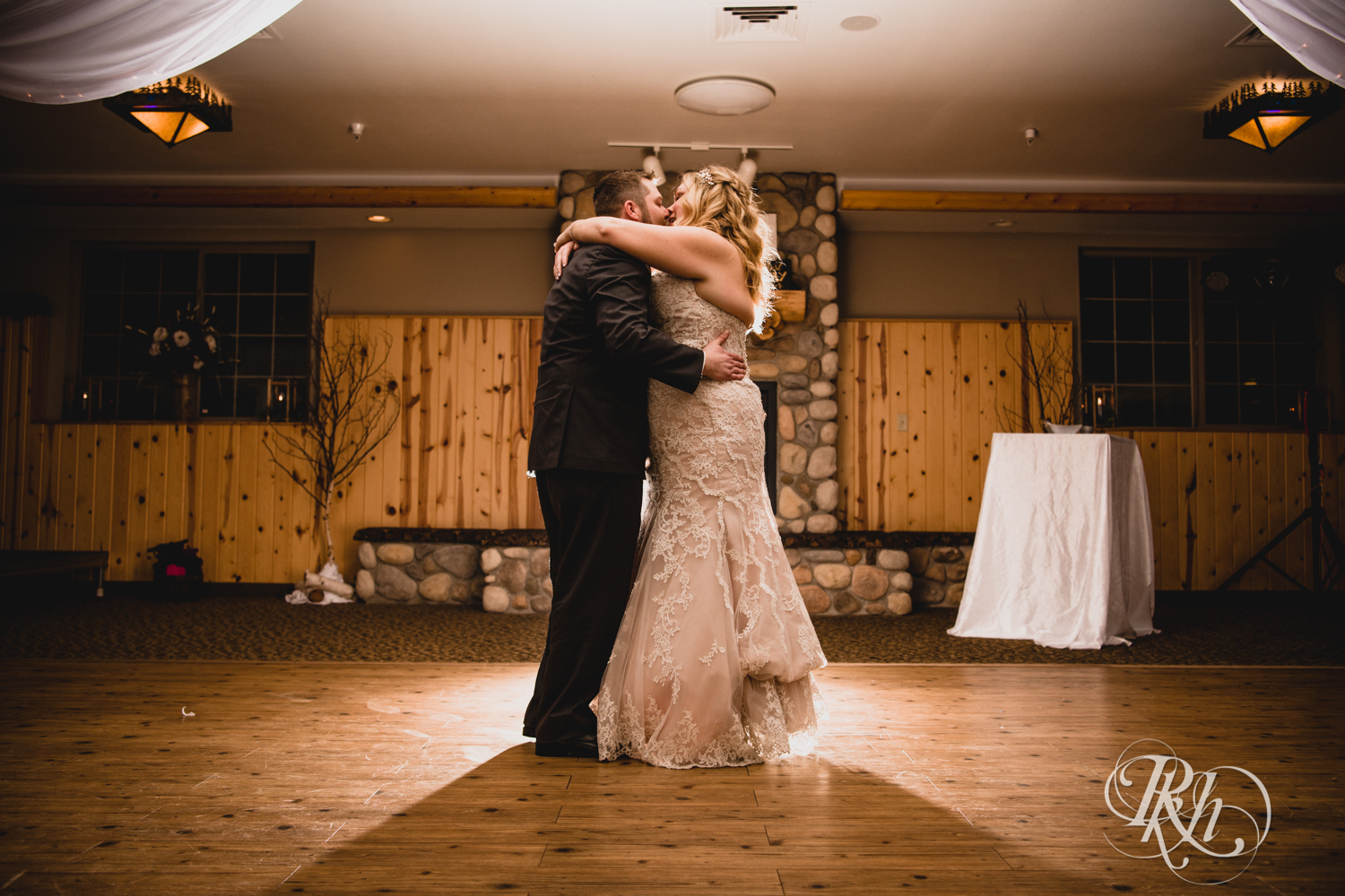 Bride and groom have first dance during winter wedding reception at Whitefish Lodge in Crosslake, Minnesota.