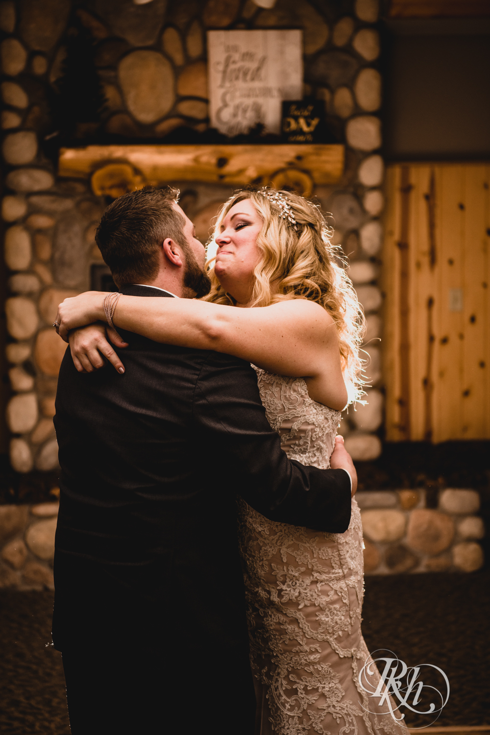 Bride and groom have first dance during winter wedding reception at Whitefish Lodge in Crosslake, Minnesota.