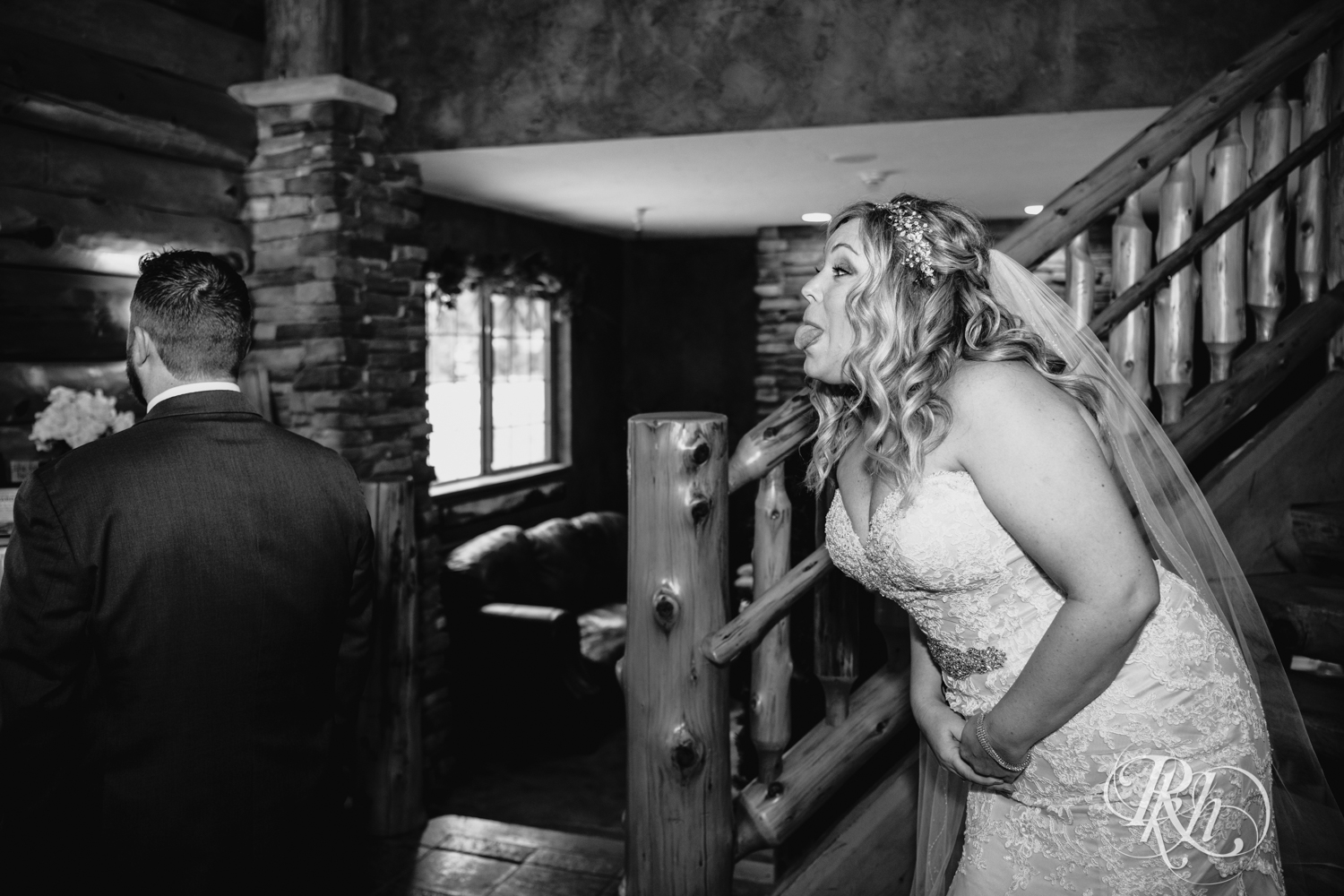 Bride sticking tongue out at groom during first look at Whitefish Lodge in Crosslake, Minnesota.