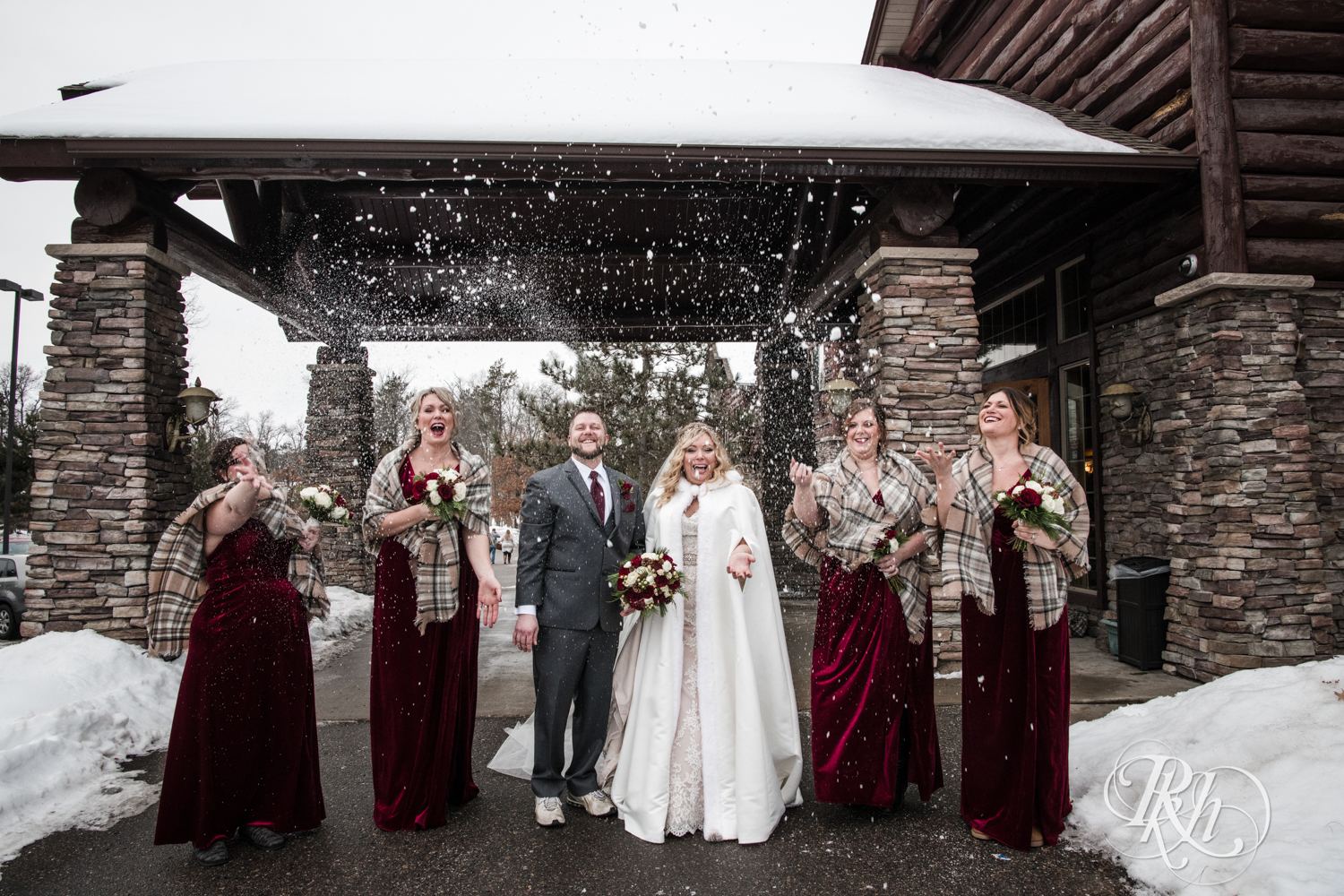 Bride and groom laugh during winter wedding at Whitefish Lodge in Crosslake, Minnesota.