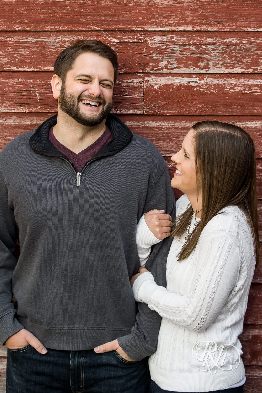 Man and woman laughing during engagement photography session at home in Annandale, Minnesota.
