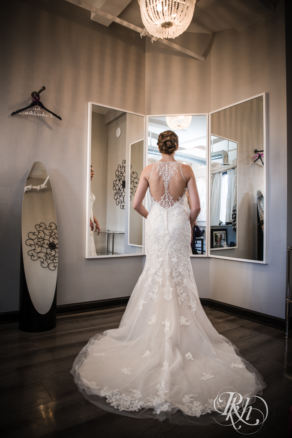 Bride stands in front of the mirror at the Lumber Exchange Event Center in Minneapolis, Minnesota.