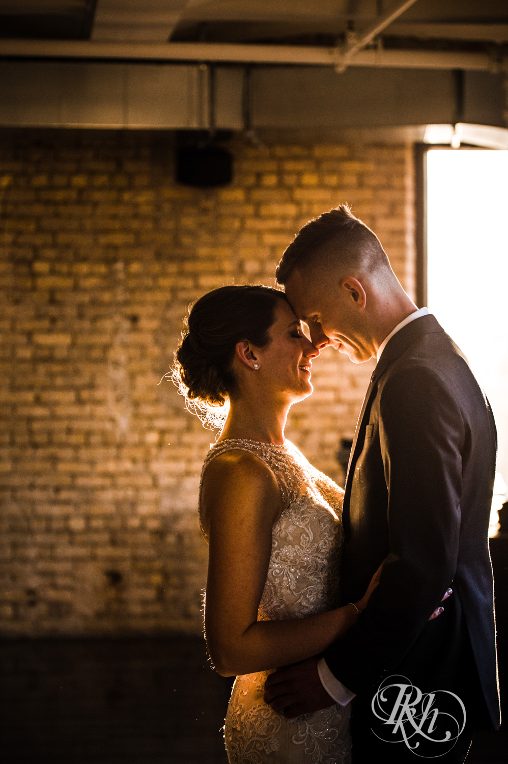 Bride and groom kiss in the Lumber Exchange Event Center in Minneapolis, Minnesota.