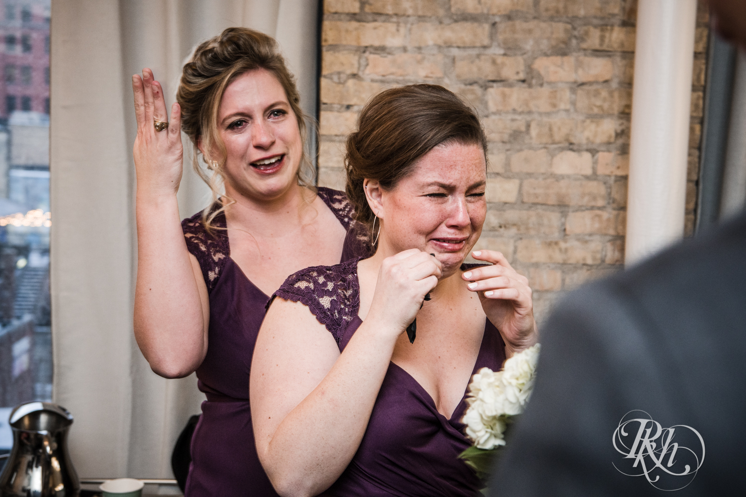Bridesmaids cry after wedding ceremony at the Lumber Exchange Event Center in Minneapolis, Minnesota.