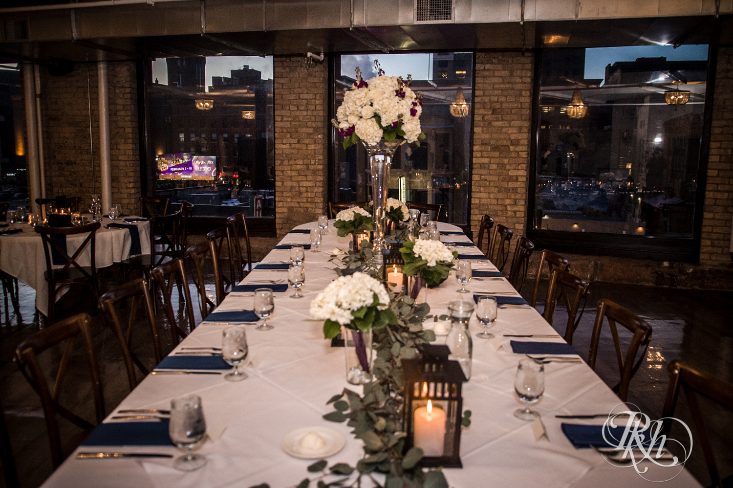 Indoor candlelit wedding reception setup at the Lumber Exchange Event Center in Minneapolis, Minnesota.