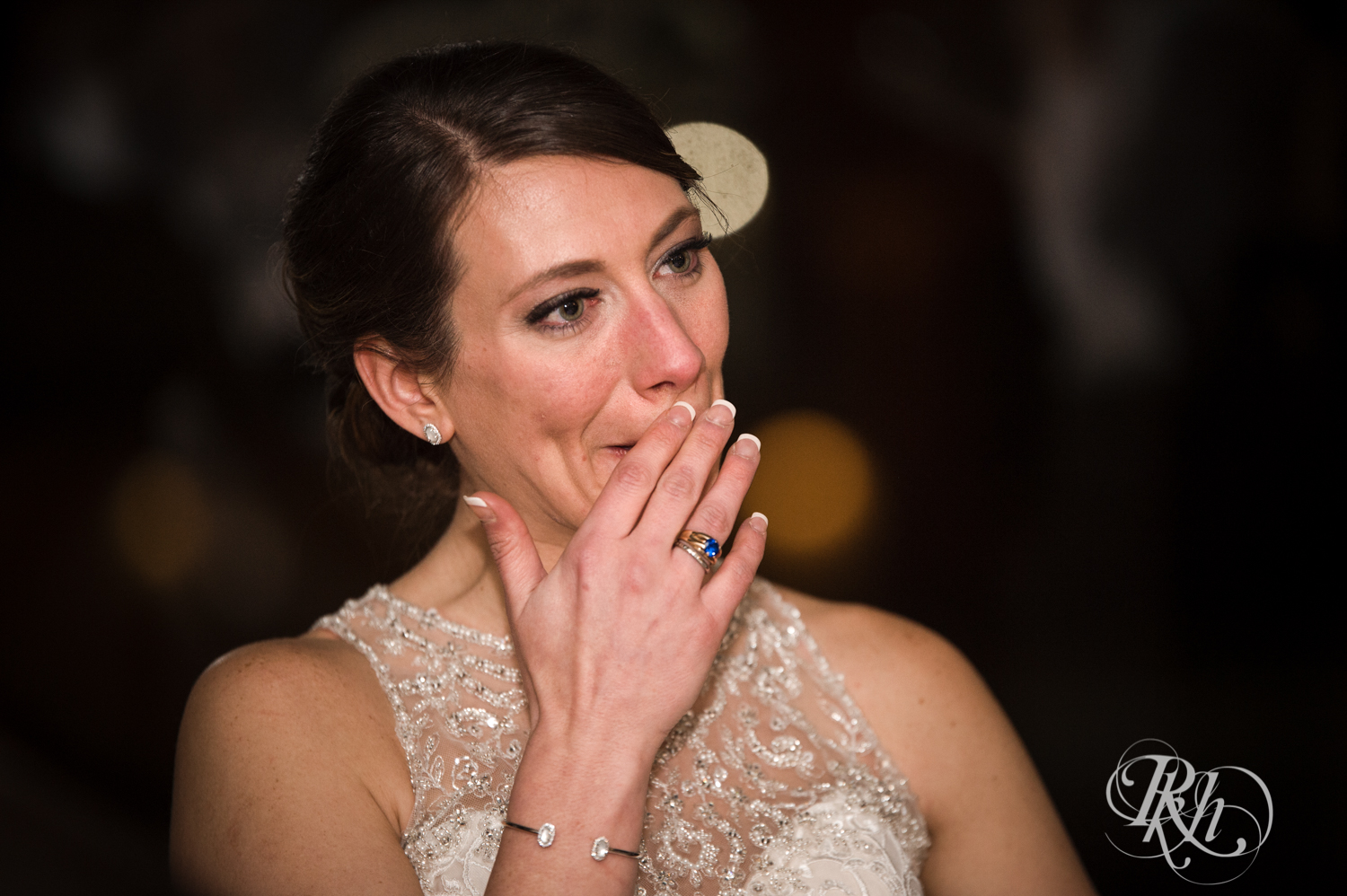 Bride cries during speeches at wedding reception at the Lumber Exchange Event Center in Minneapolis, Minnesota.