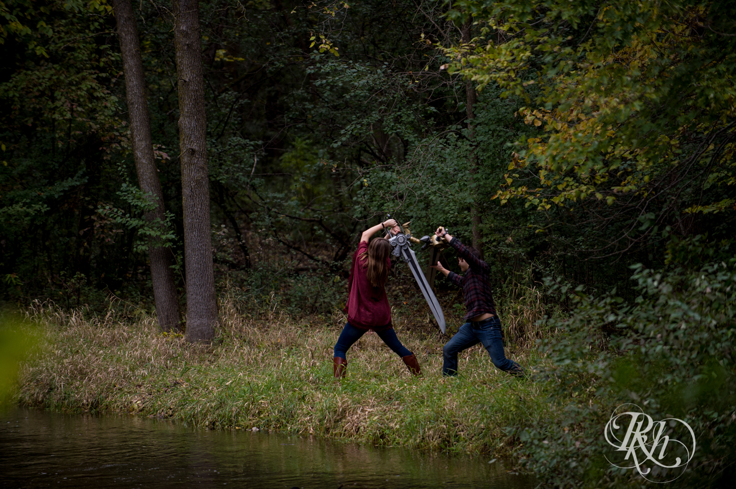 Man and woman have swordfight during cosplay engagement photography in Minneapolis, Minnesota.