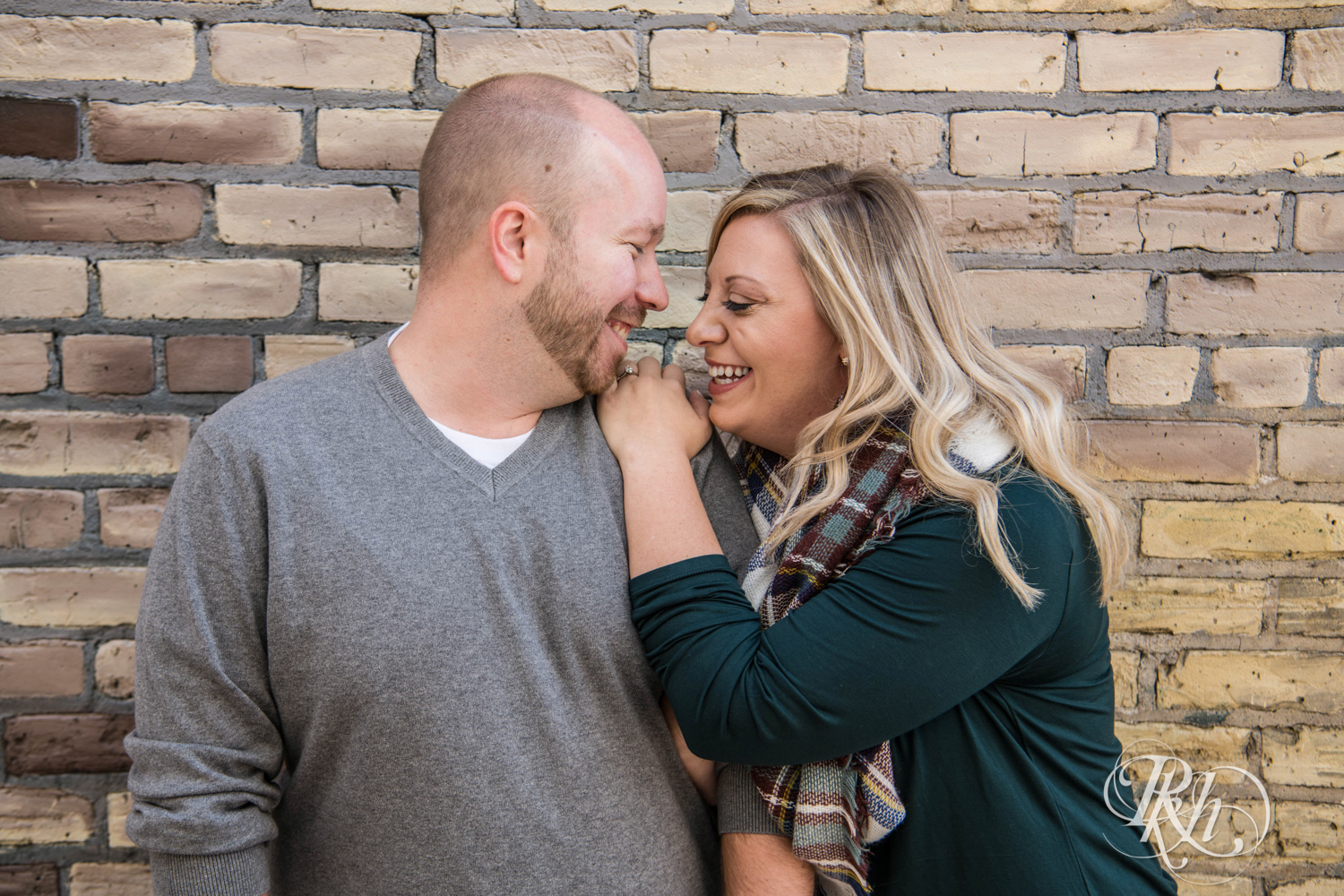 Man and woman laugh during engagement photos in Loring Park in Minneapolis, Minnesota.