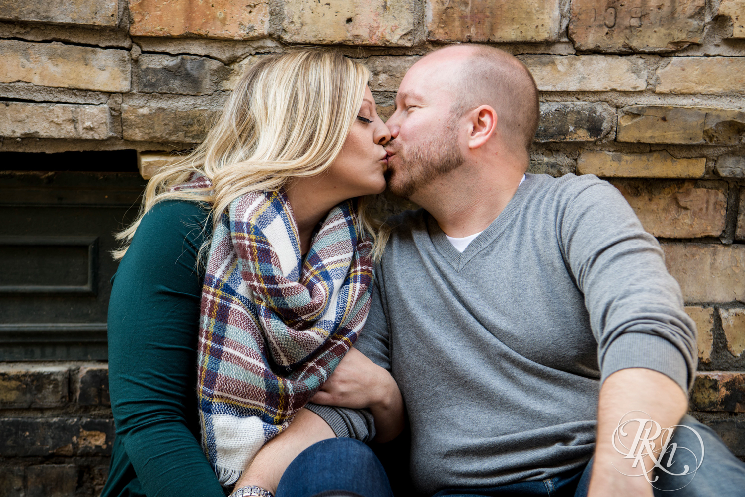 Man and woman kiss during engagement photos in Loring Park in Minneapolis, Minnesota.