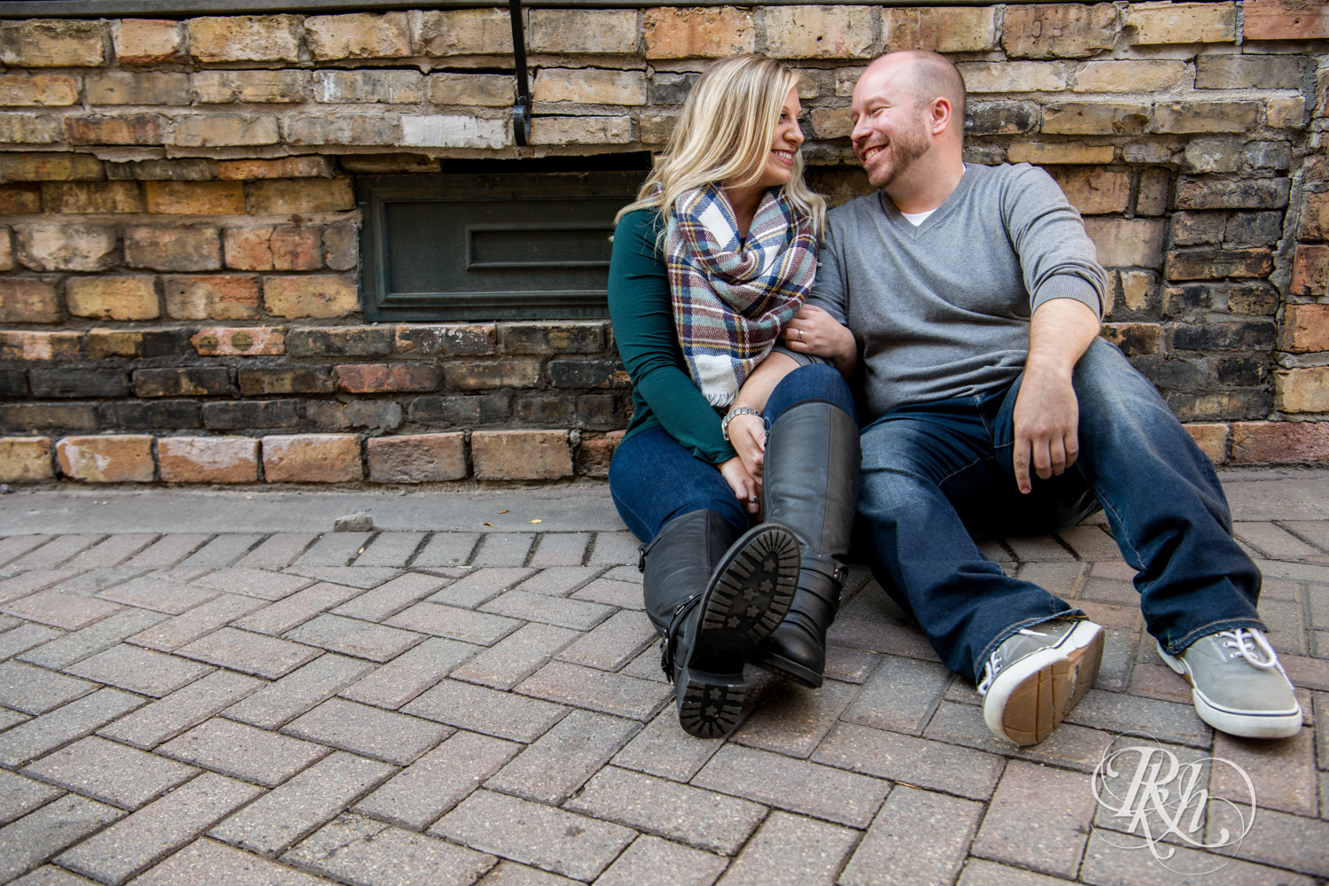 Man and woman laugh during engagement photos in Loring Park in Minneapolis, Minnesota.