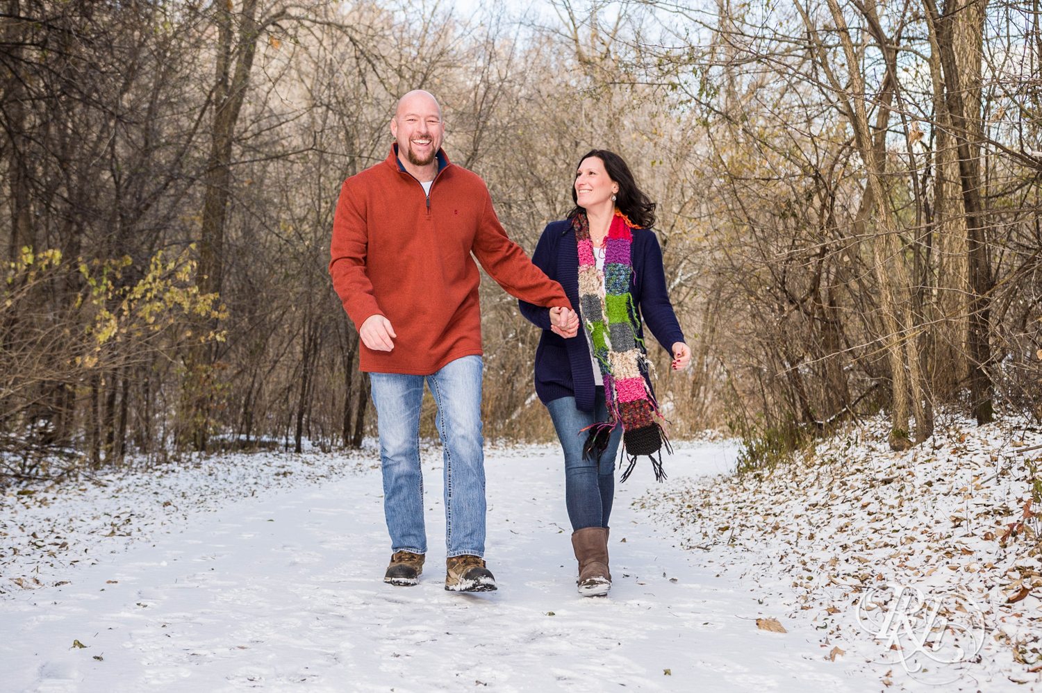 Man and woman laugh while walking in snow in Hidden Valley Park in Savage, Minnesota.
