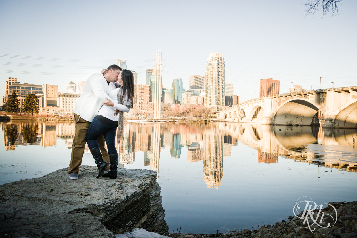 Man and woman kiss in Minneapolis, Minnesota at sunrise.