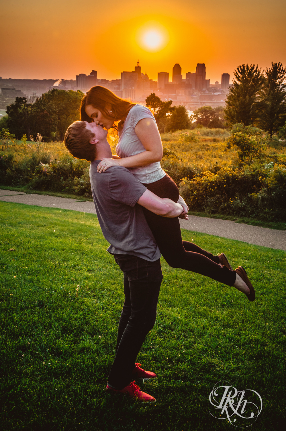 Man and woman kiss at Indian Mounds Regional Park in Saint Paul, Minnesota at sunset.