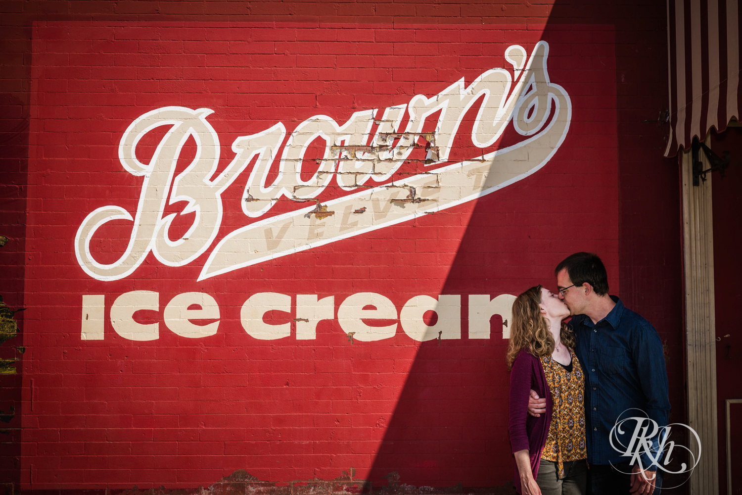Man and woman kiss in front of the Brown's Ice Cream parlor in Stillwater, Minnesota.