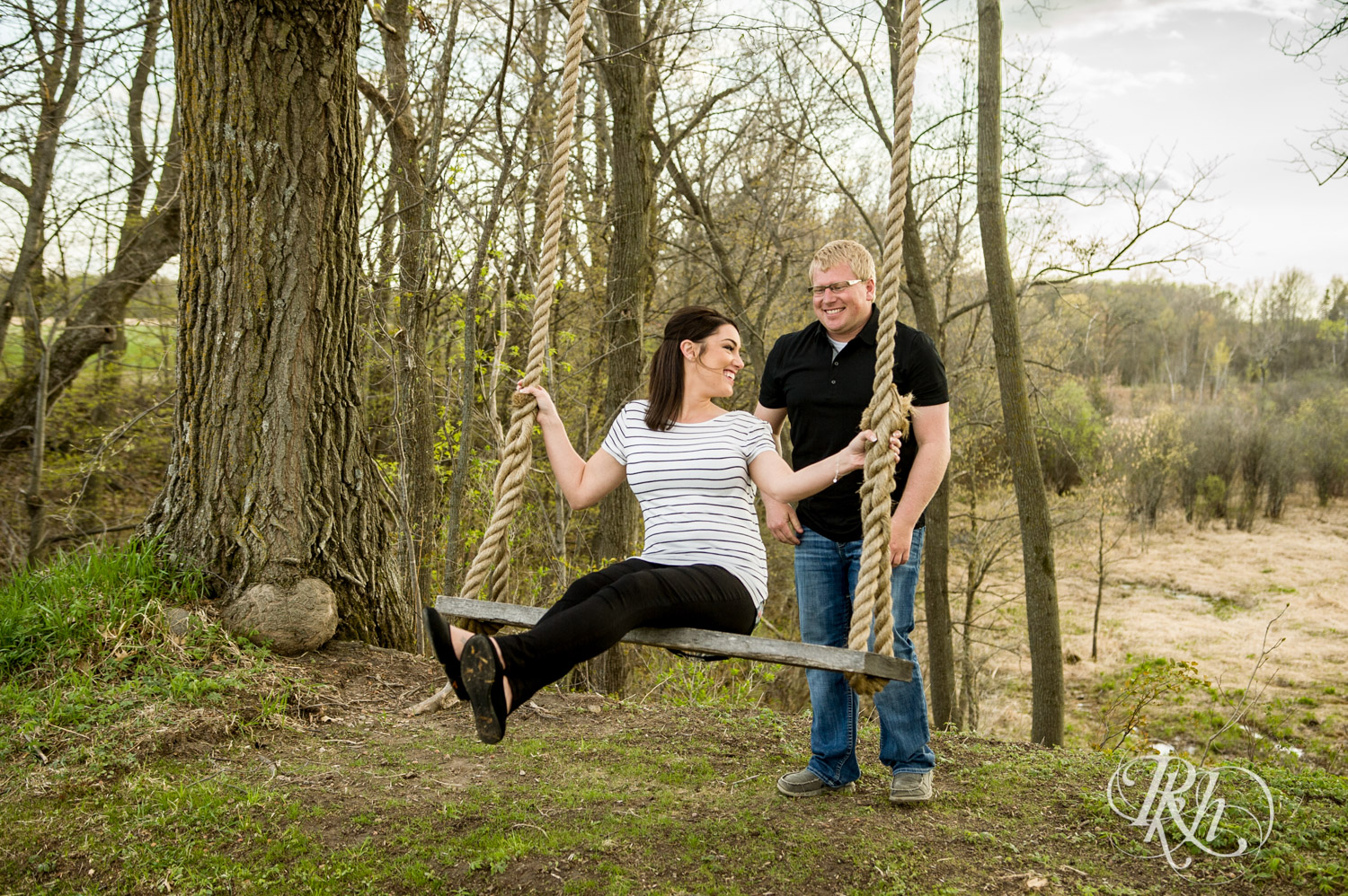 Man and woman laugh on swing at Creekside Farm and Events in Rush City, Minnesota.