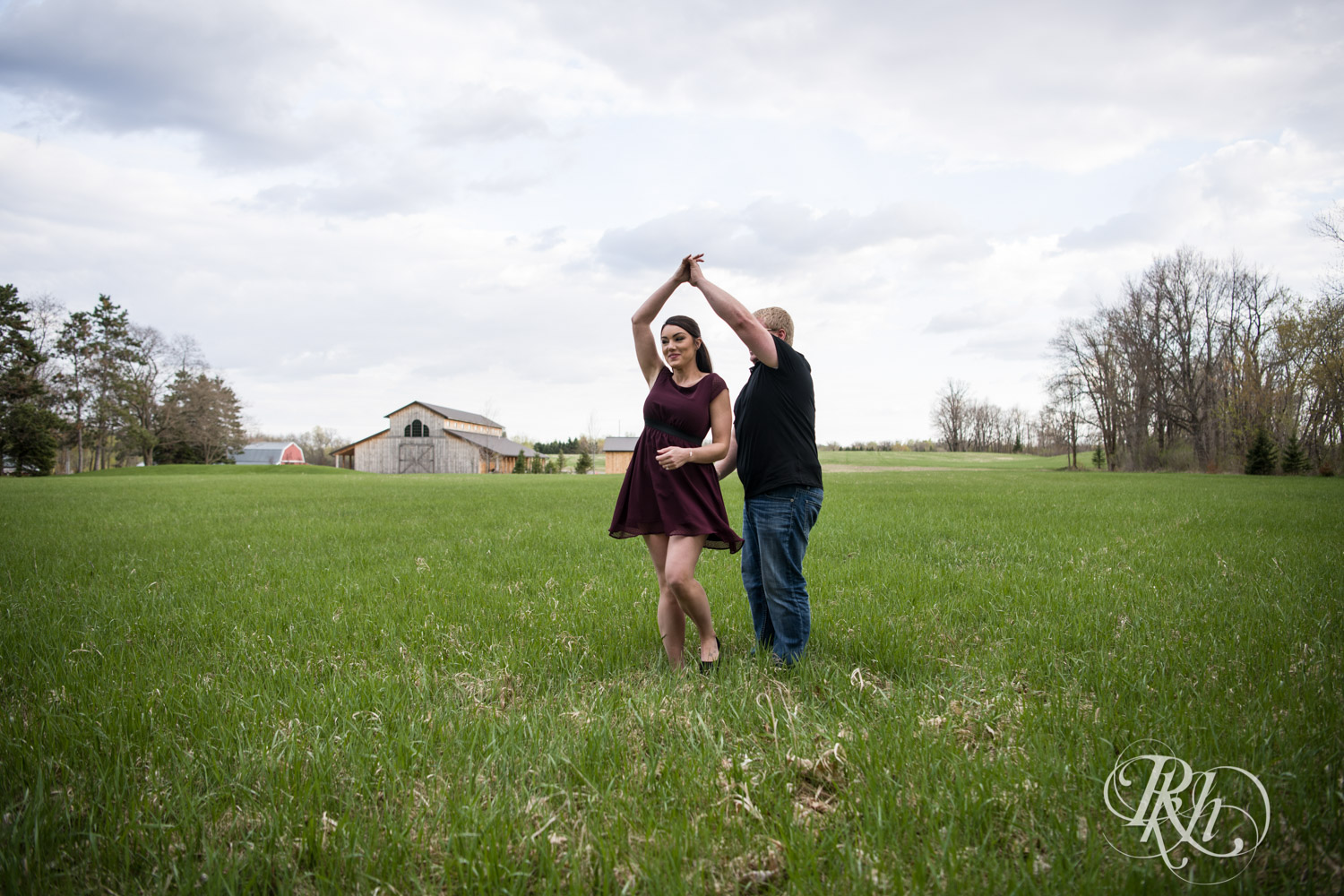 Man and woman dance in field at Creekside Farm and Events in Rush City, Minnesota.