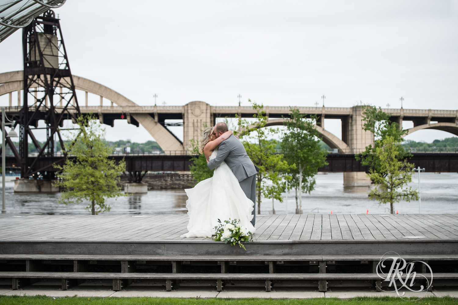 Bride and groom kiss at the Minnesota Boat Club on Raspberry Island in Saint Paul, Minnesota.