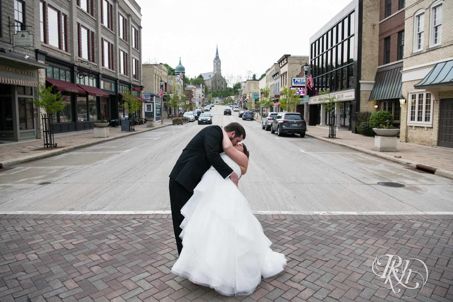 Bride and groom kiss in the street in Port Washington, Wisconsin