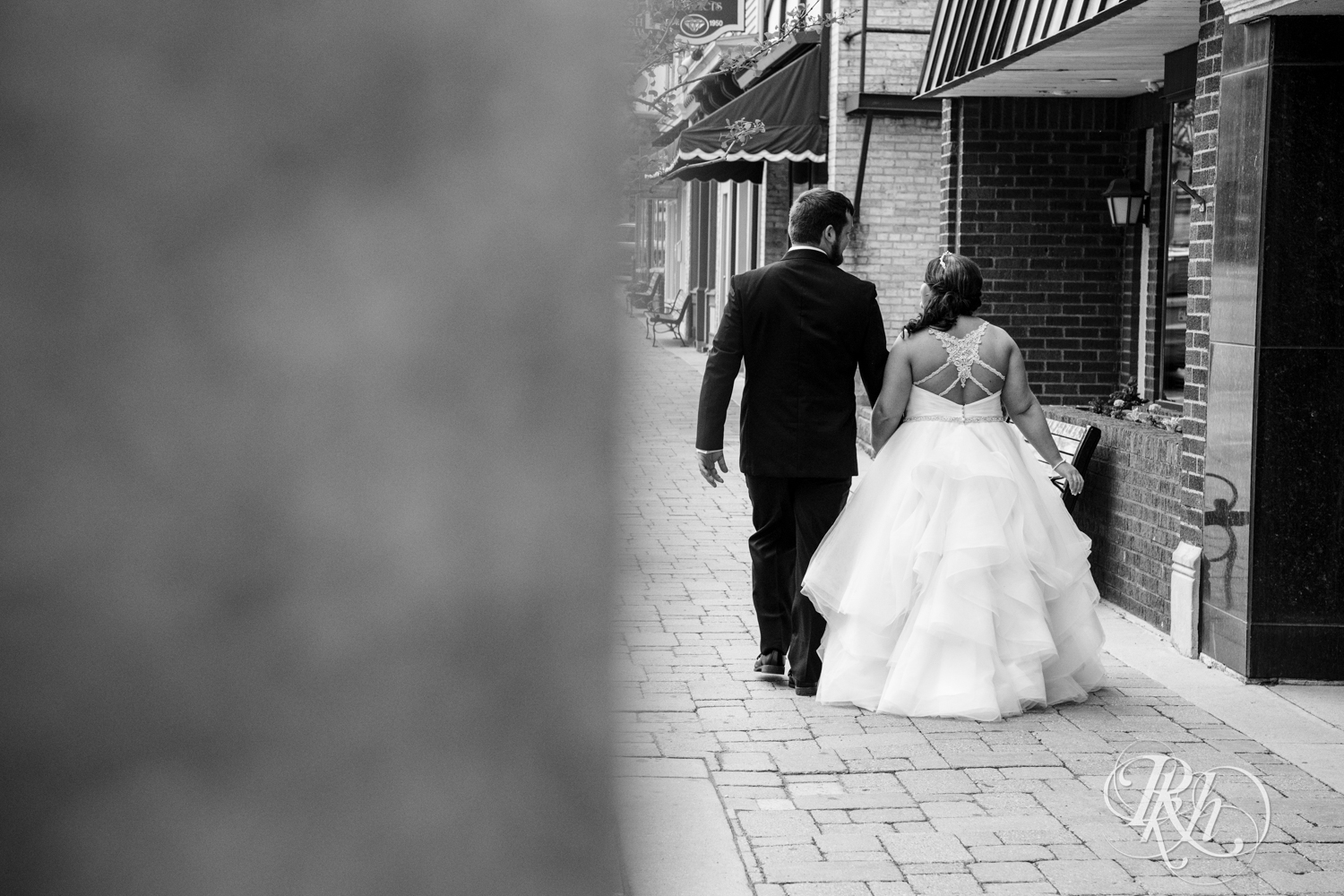 Bride and groom walk on the sidewalk in Port Washington, Wisconsin