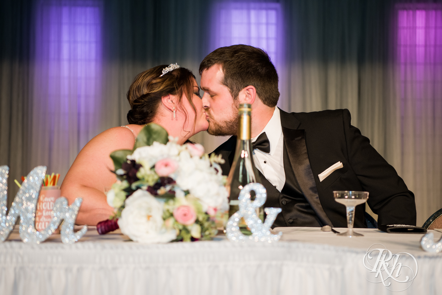 Bride and groom kiss during wedding reception at Memories Ballroom in Port Washington, Wisconsin. 