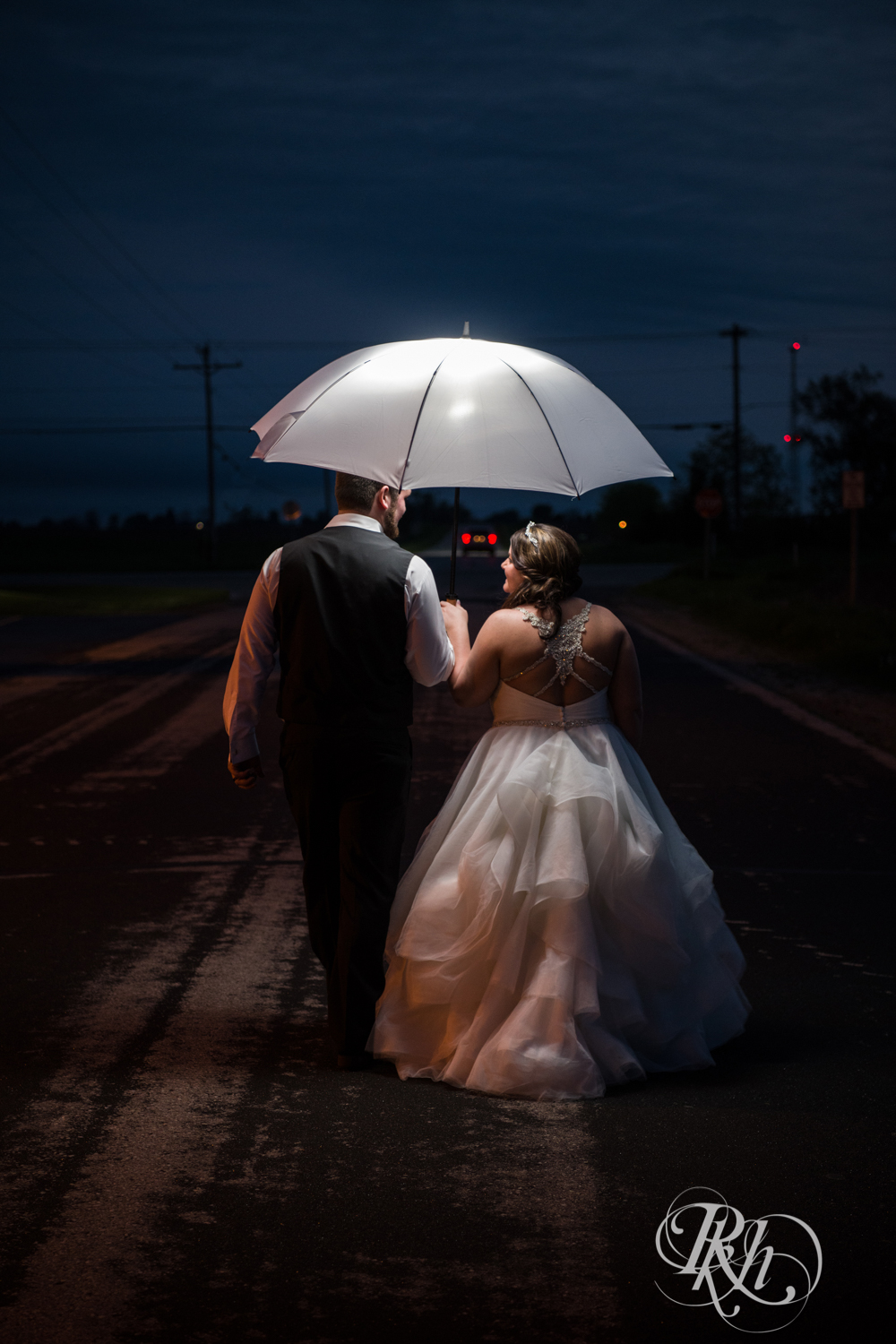 Bride and groom kiss at night in Port Washington, Wisconsin. 