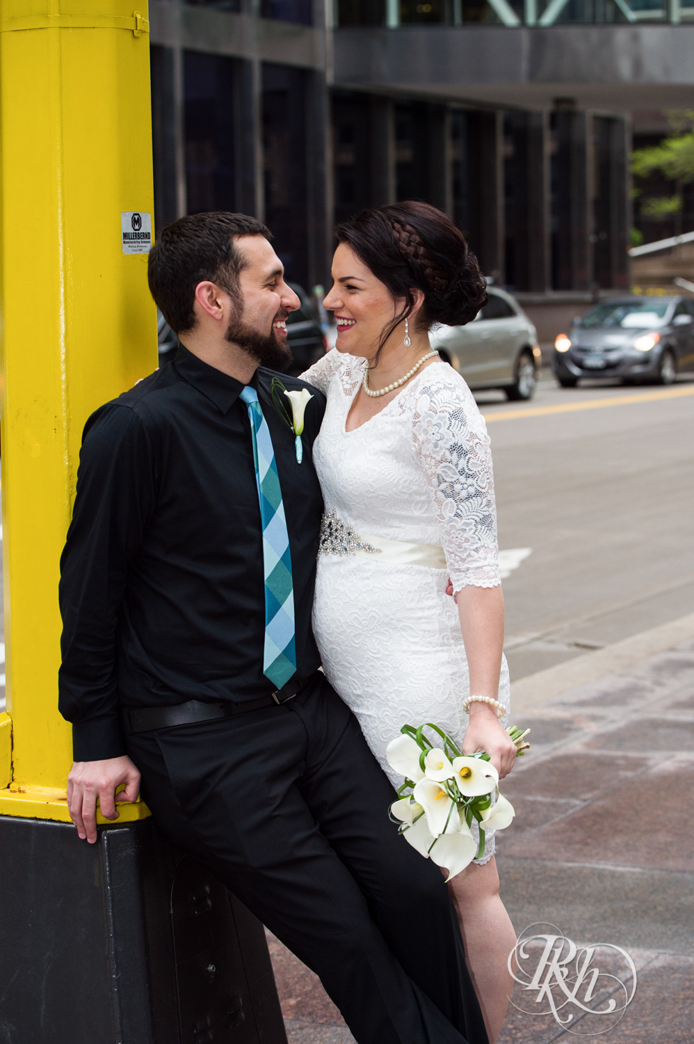 Bride and groom smile in Minneapolis, Minnesota before their courthouse wedding.