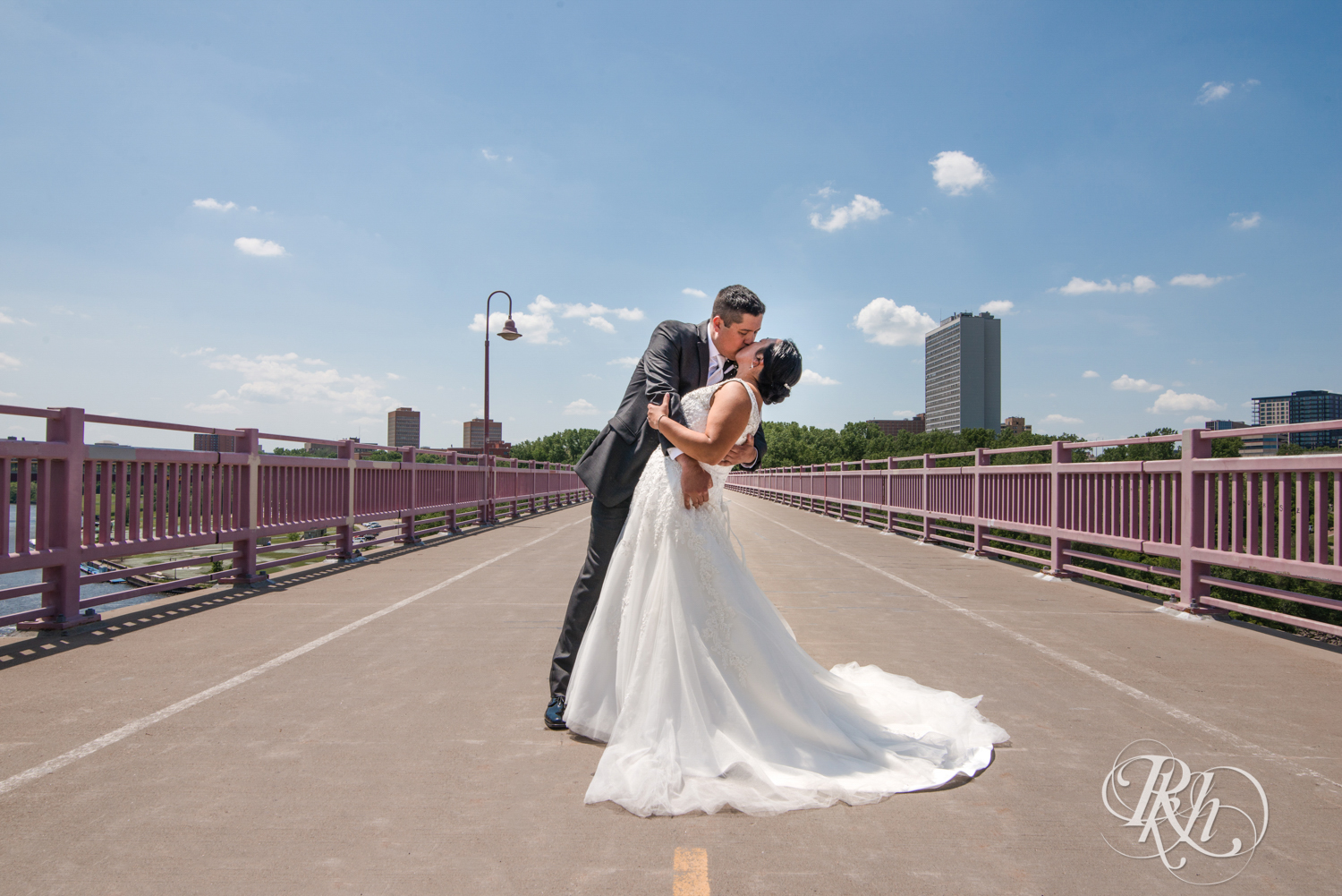 Bride and groom kiss on the 10th Avenue Bridge in Minneapolis, Minnesota.