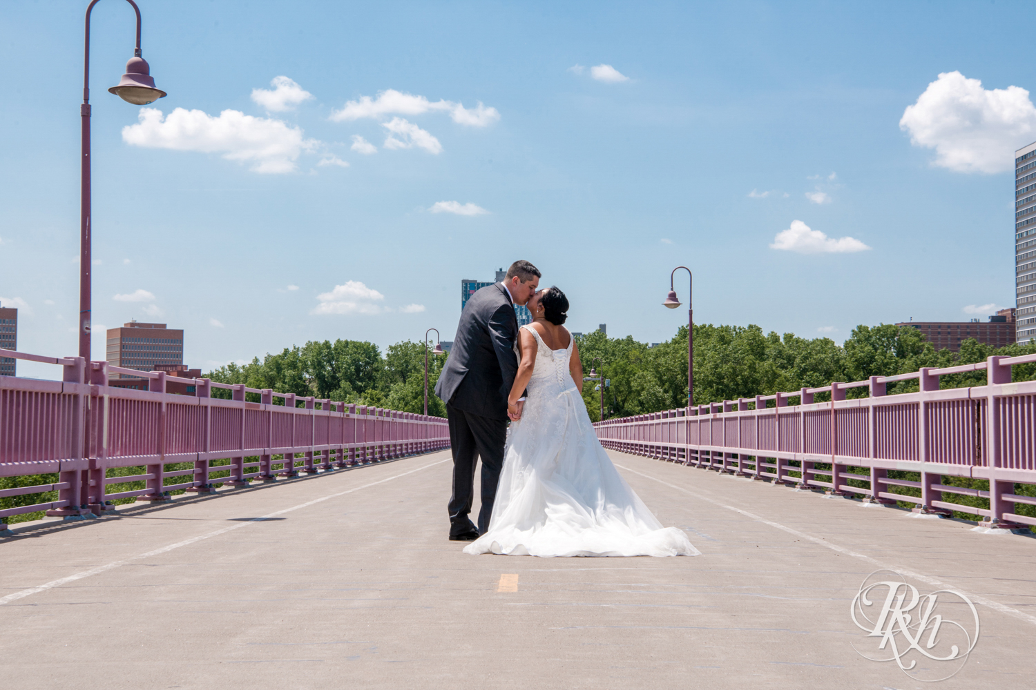 Bride and groom kiss on the 10th Avenue Bridge in Minneapolis, Minnesota.