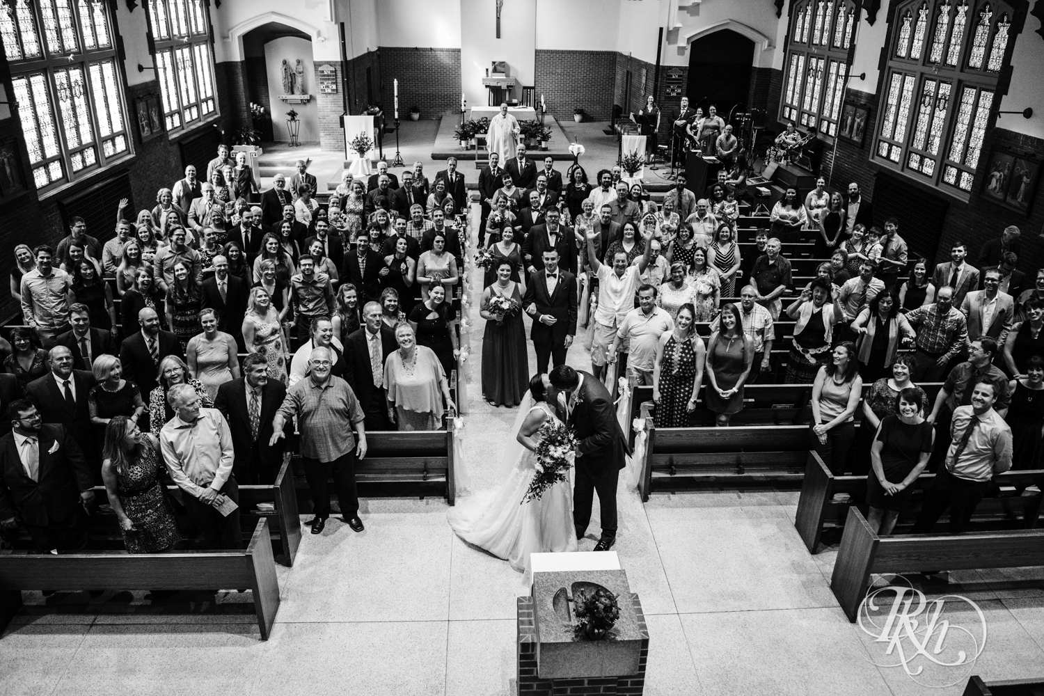 Bride and groom kiss during church wedding ceremony in Minneapolis, Minnesota.