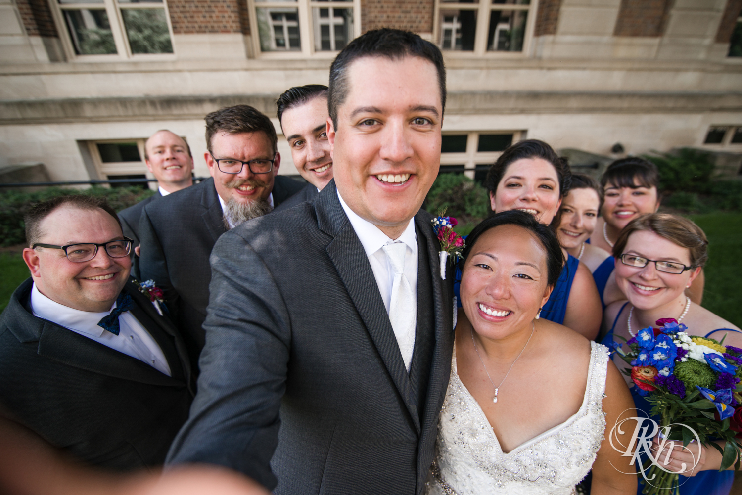 Wedding party smiles and laughs at the University of Minnesota in Minneapolis, Minnesota.