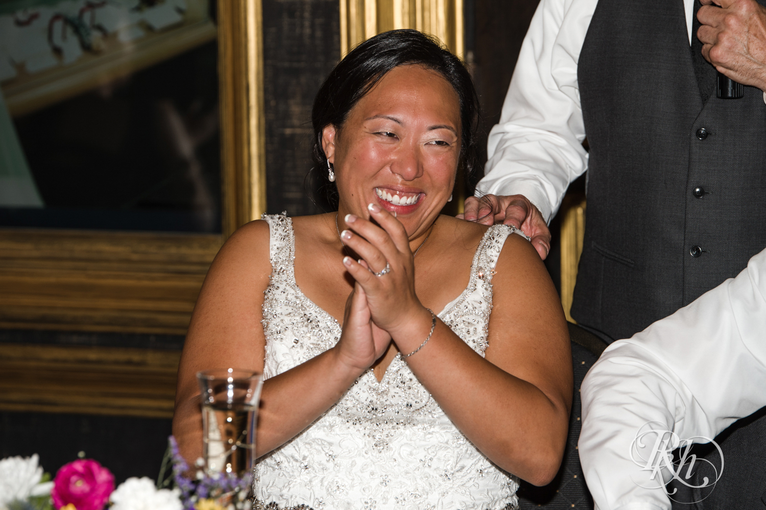 Bride and groom laugh during wedding reception at Kellerman's Event Center in White Bear Lake, Minnesota.