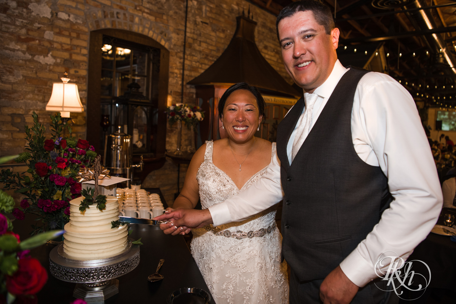 Bride and groom cut cake during wedding reception at Kellerman's Event Center in White Bear Lake, Minnesota.