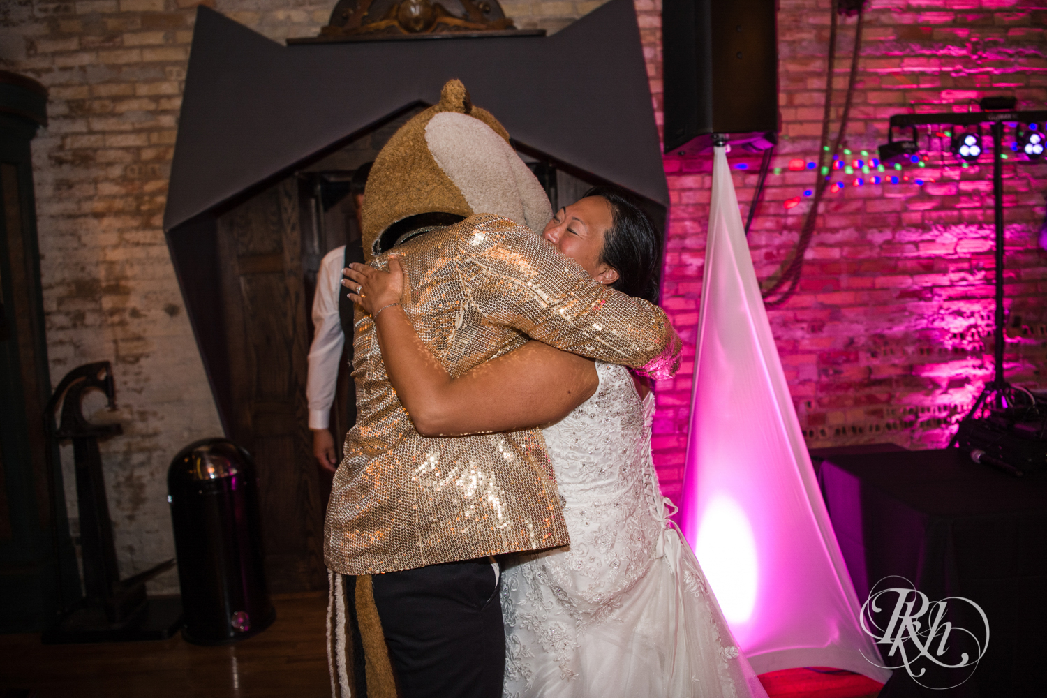 Goldy Gopher hugs bride at wedding reception at Kellerman's Event Center in White Bear Lake, Minnesota.