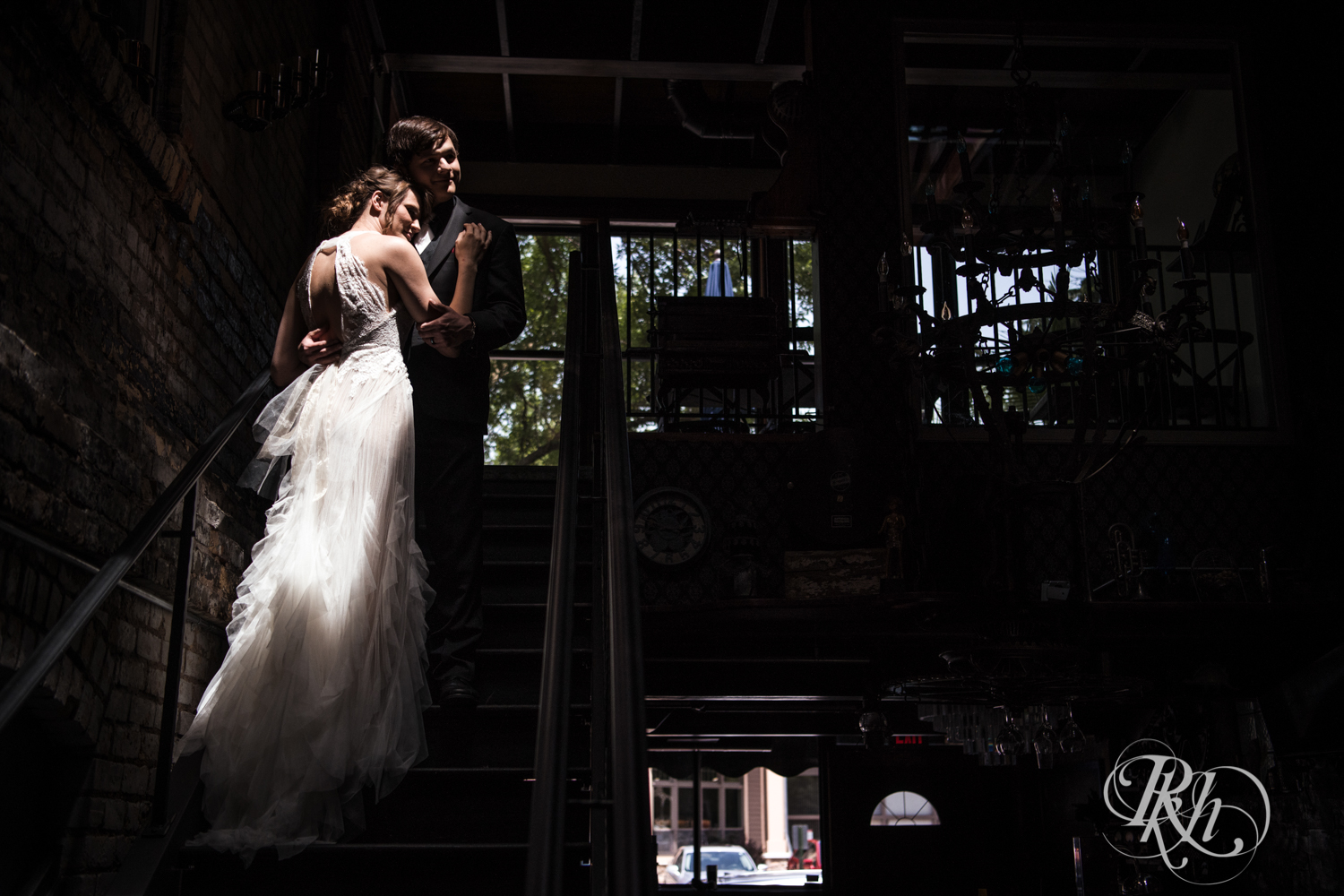 Bride and groom smile on stairs at Kellerman's Event Center in White Bear Lake, Minnesota.
