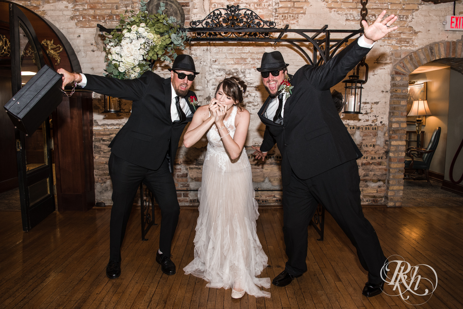Bride plays harmonica with brothers dressed as The Blues Brothers at Kellerman's Event Center in White Bear Lake, Minnesota.