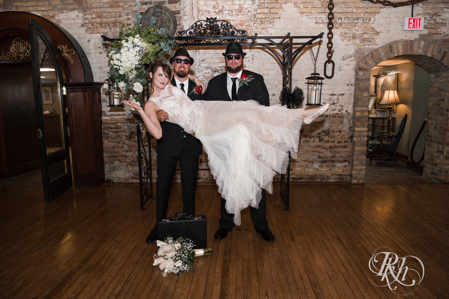 Bride held up by brothers dressed as The Blues Brothers at Kellerman's Event Center in White Bear Lake, Minnesota.