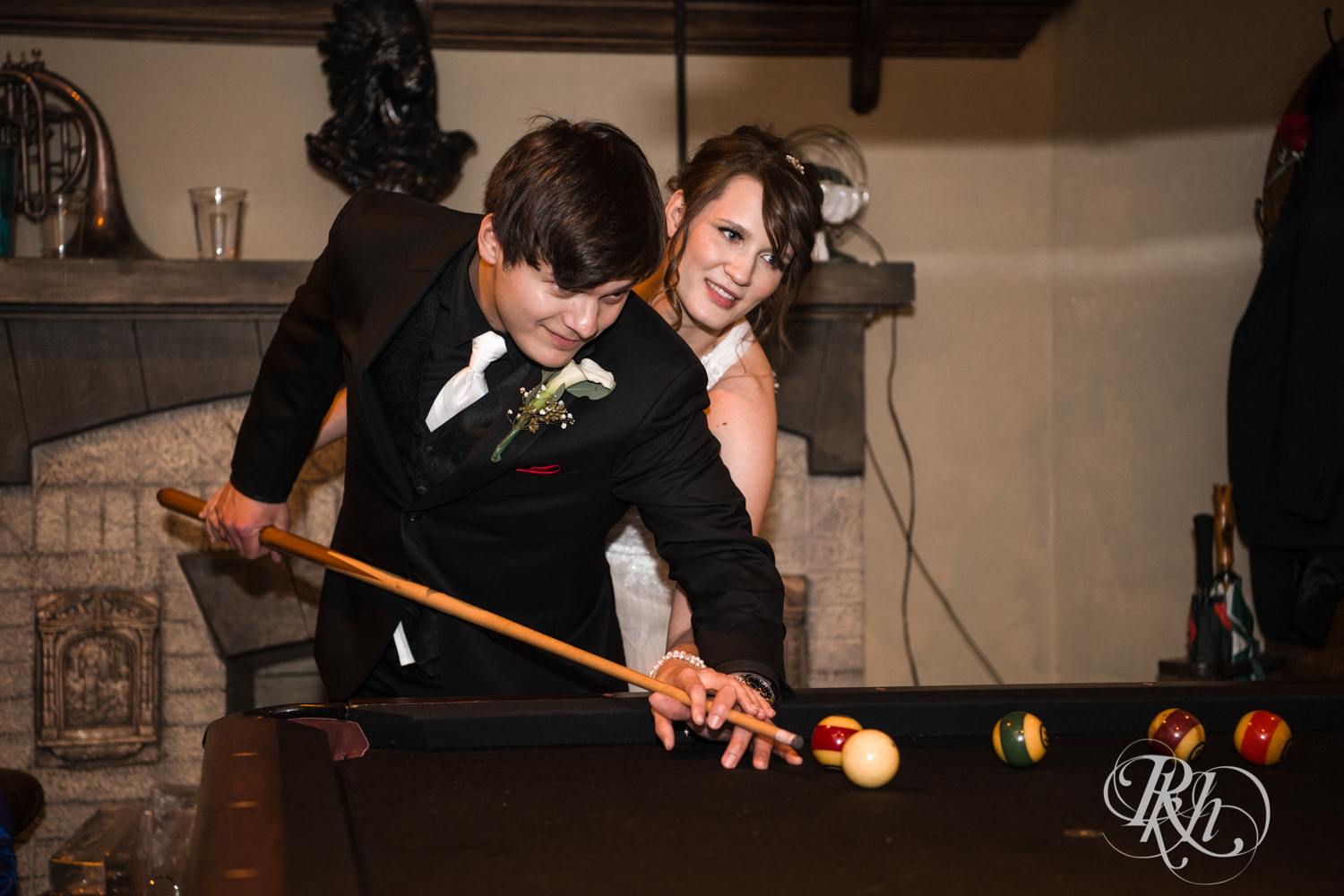 Bride and groom play pool at Kellerman's Event Center in White Bear Lake, Minnesota.
