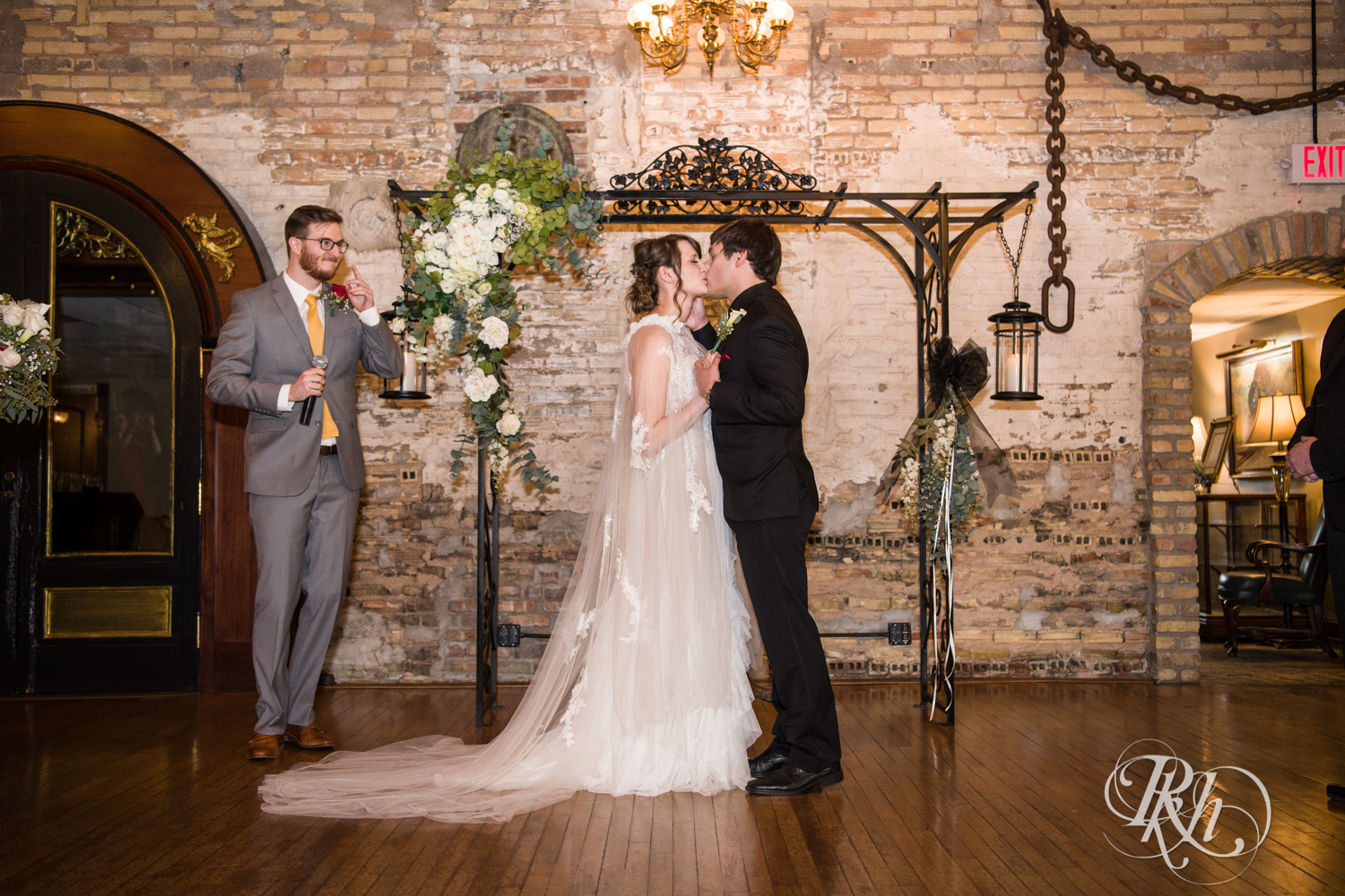 Bride and groom kiss at wedding ceremony at Kellerman's Event Center in White Bear Lake, Minnesota.