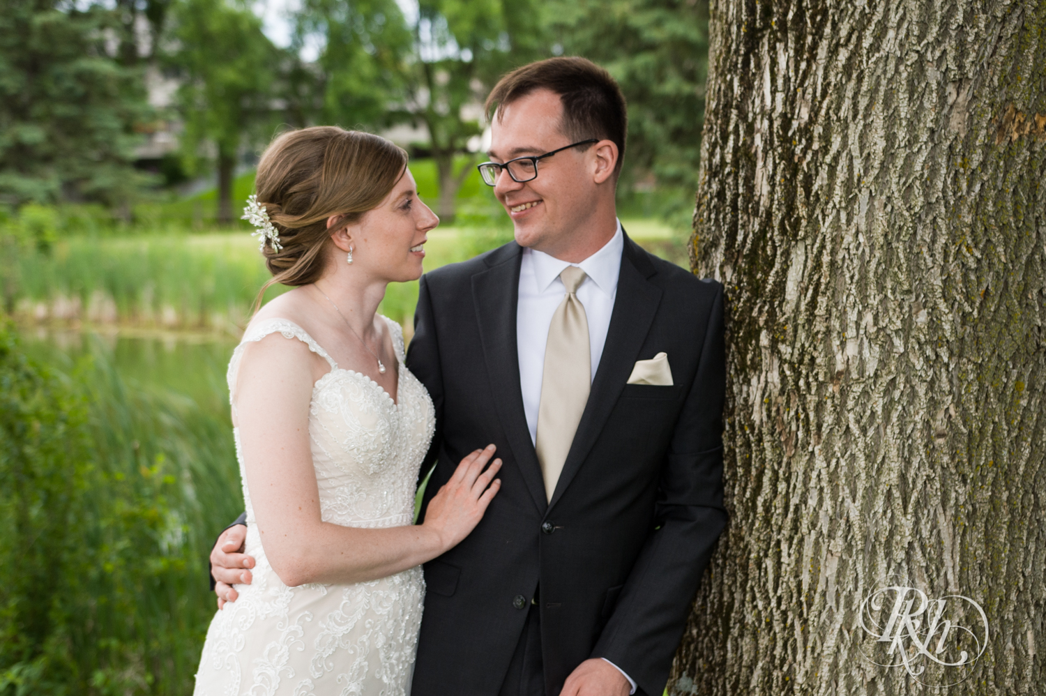 Bride and groom smile at Oak Glen Golf Course in Stillwater, Minnesota.