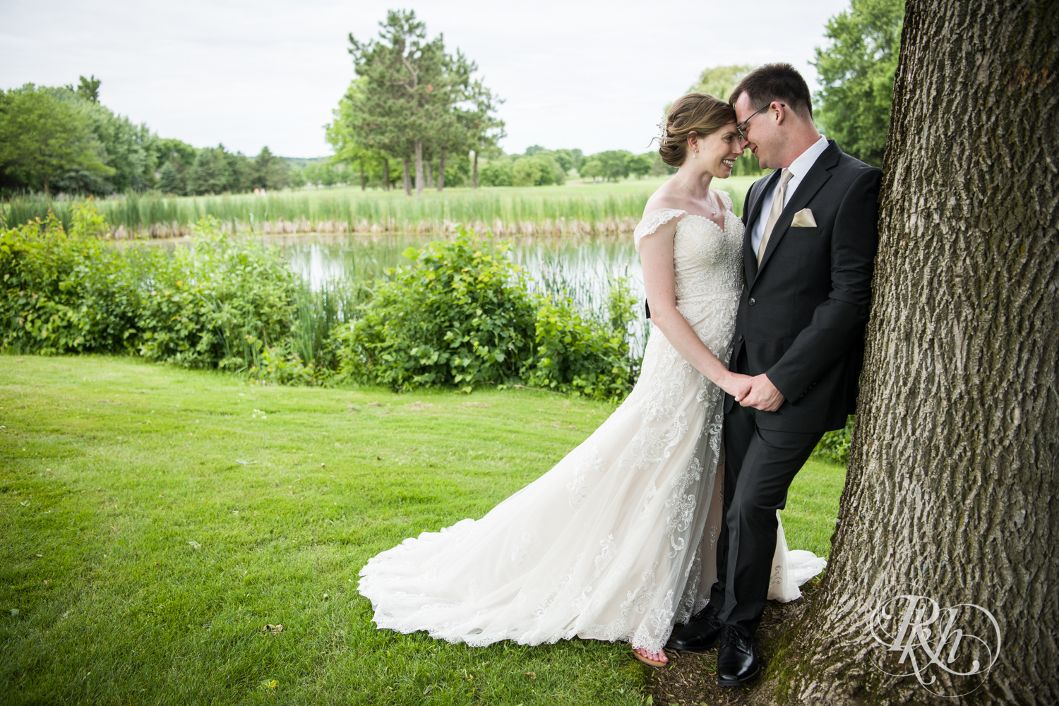 Bride and groom smile at Oak Glen Golf Course in Stillwater, Minnesota.