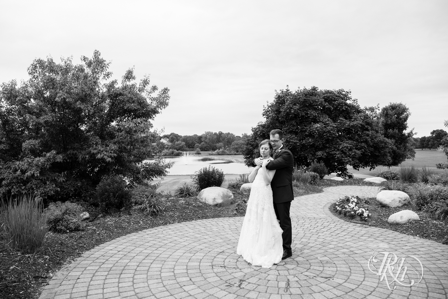 Bride and groom kiss after wedding ceremony at Oak Glen Golf Course in Stillwater, Minnesota.