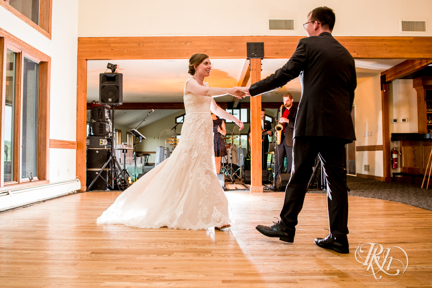 Bride and groom dance during wedding reception speeches at Oak Glen Golf Course in Stillwater, Minnesota.