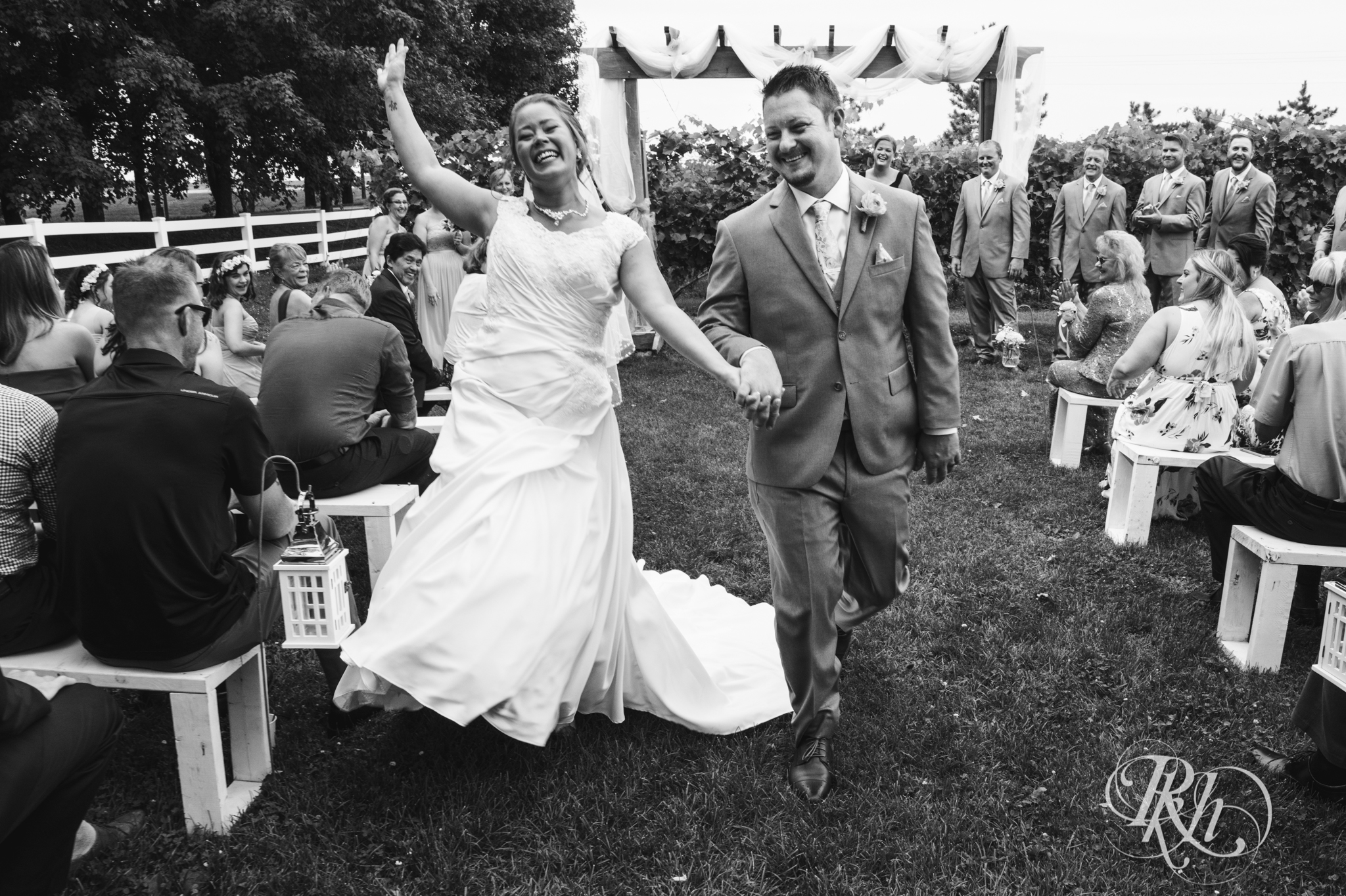 Bride and groom dancing down aisle after wedding ceremony at Next Chapter Winery in New Prague, Minnesota.